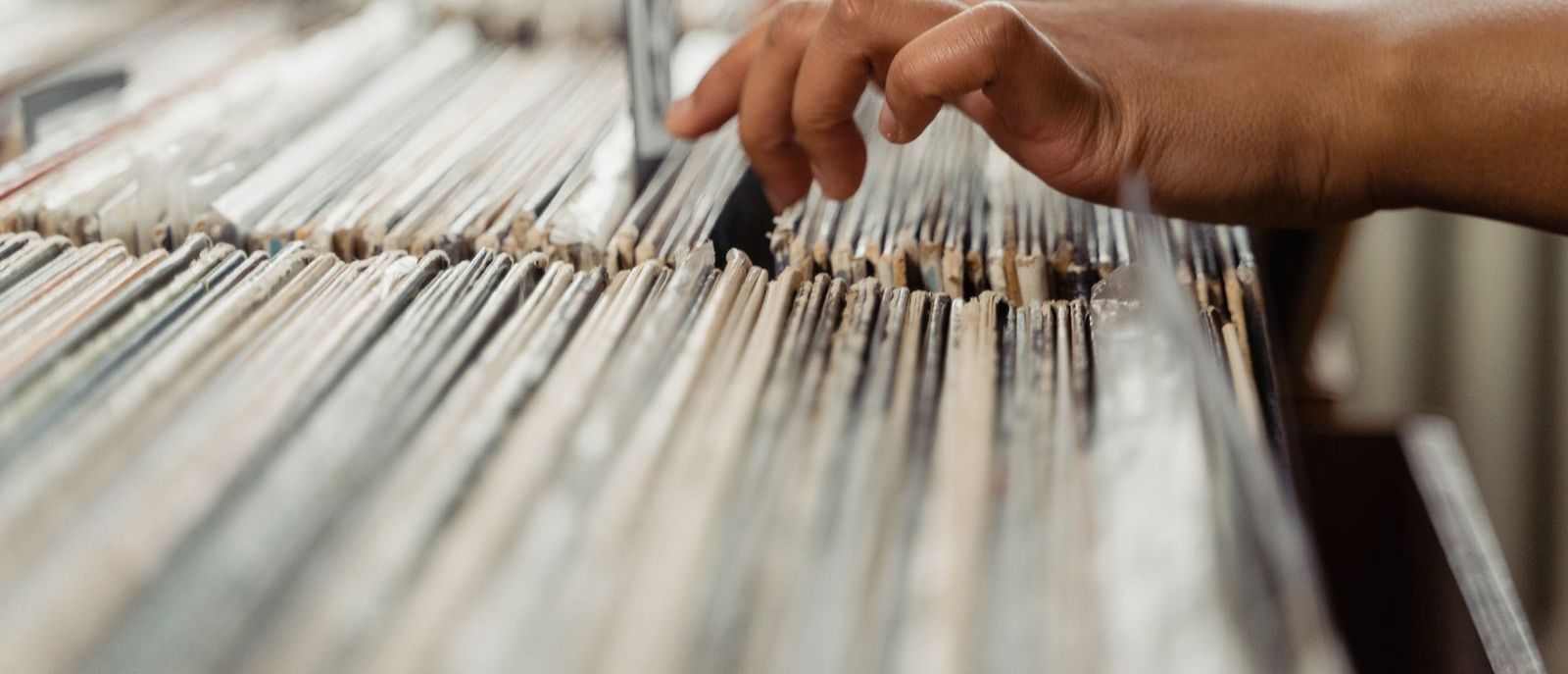 Flipping through records in a shop crate.