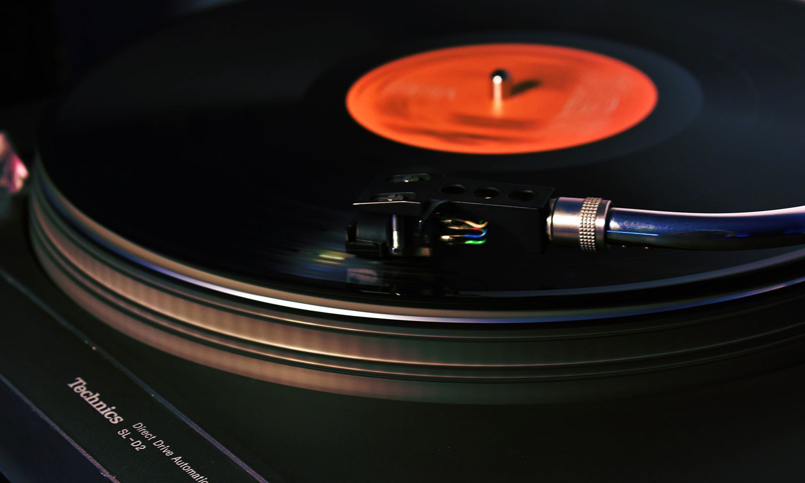 A stylus resting on a spinning record.